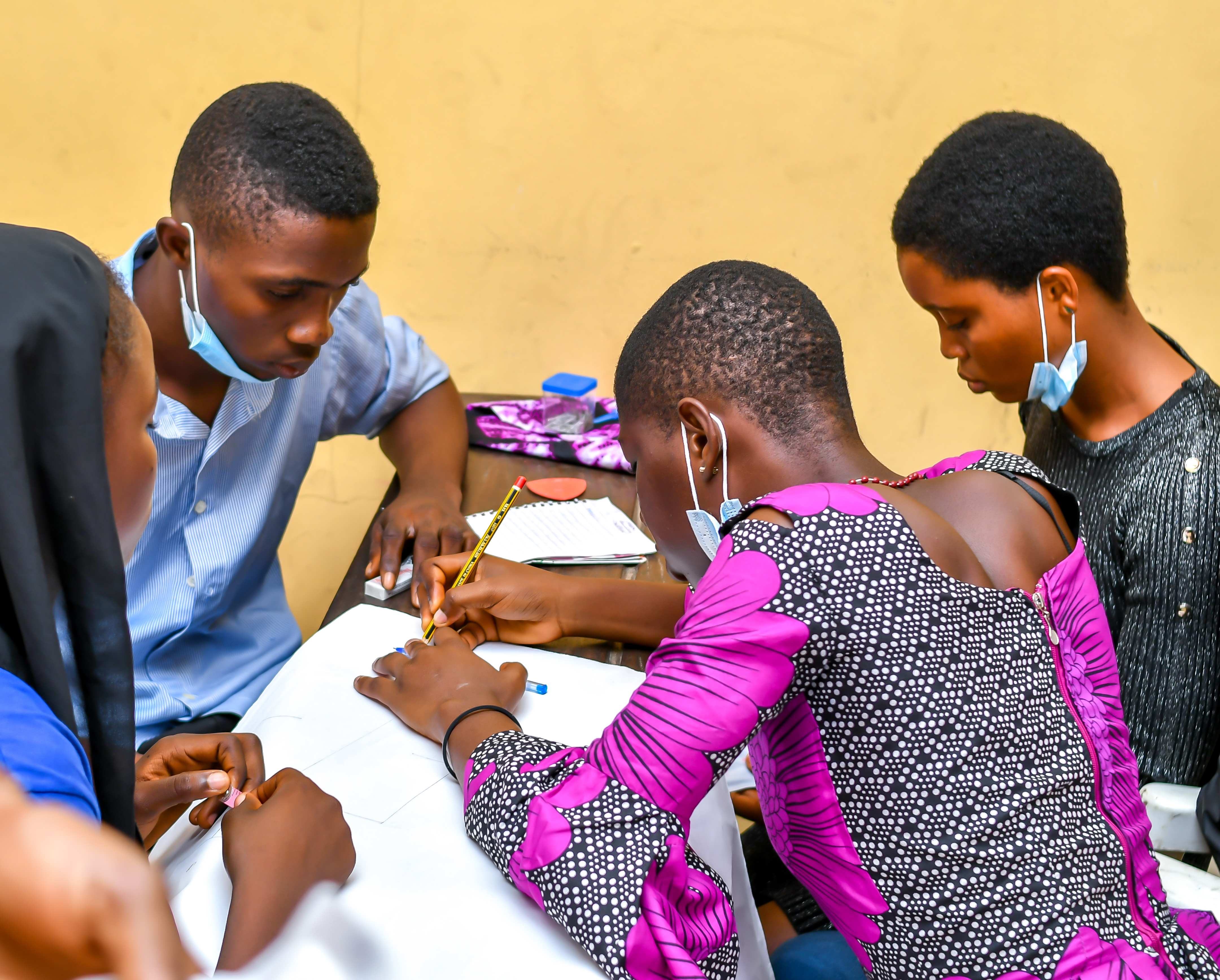 workshop participants learning pad making skills